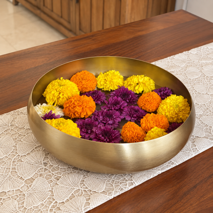 Ekam Metal Urli filled with marigold flowers