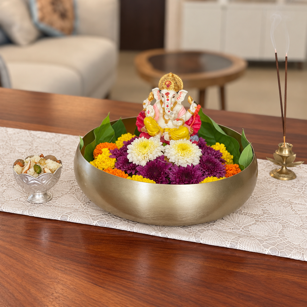 Ekam Metal Urli filled with flowers in front of a Ganesha idol