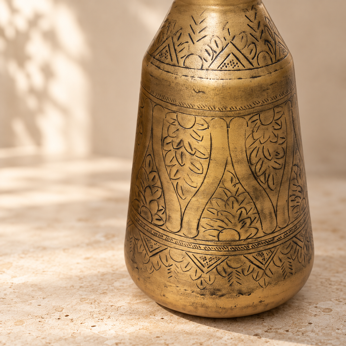 Close-up of the three hand-etched bands on the Aurum antique brass finish vase