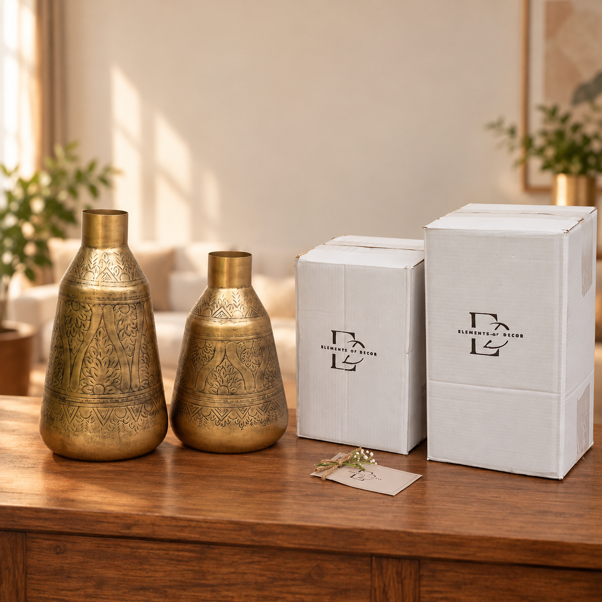 Two Aurum vases beside two Elements of Decor gift boxes and a thank-you card