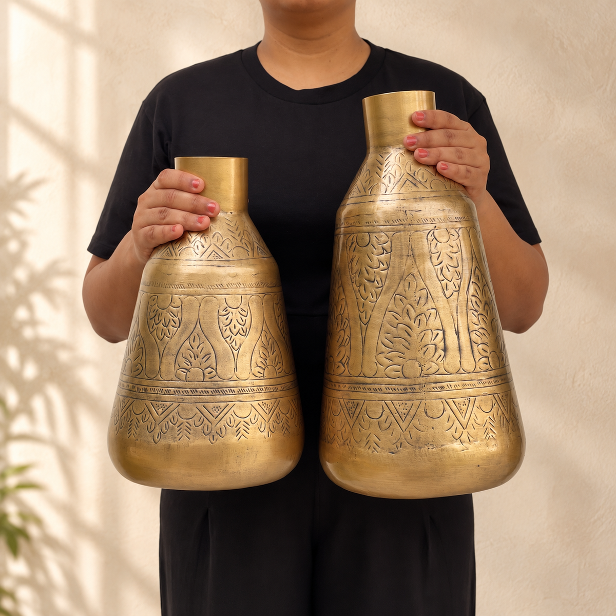 Person holding the Aurum 12 inch and 15 inch vases to show their scale