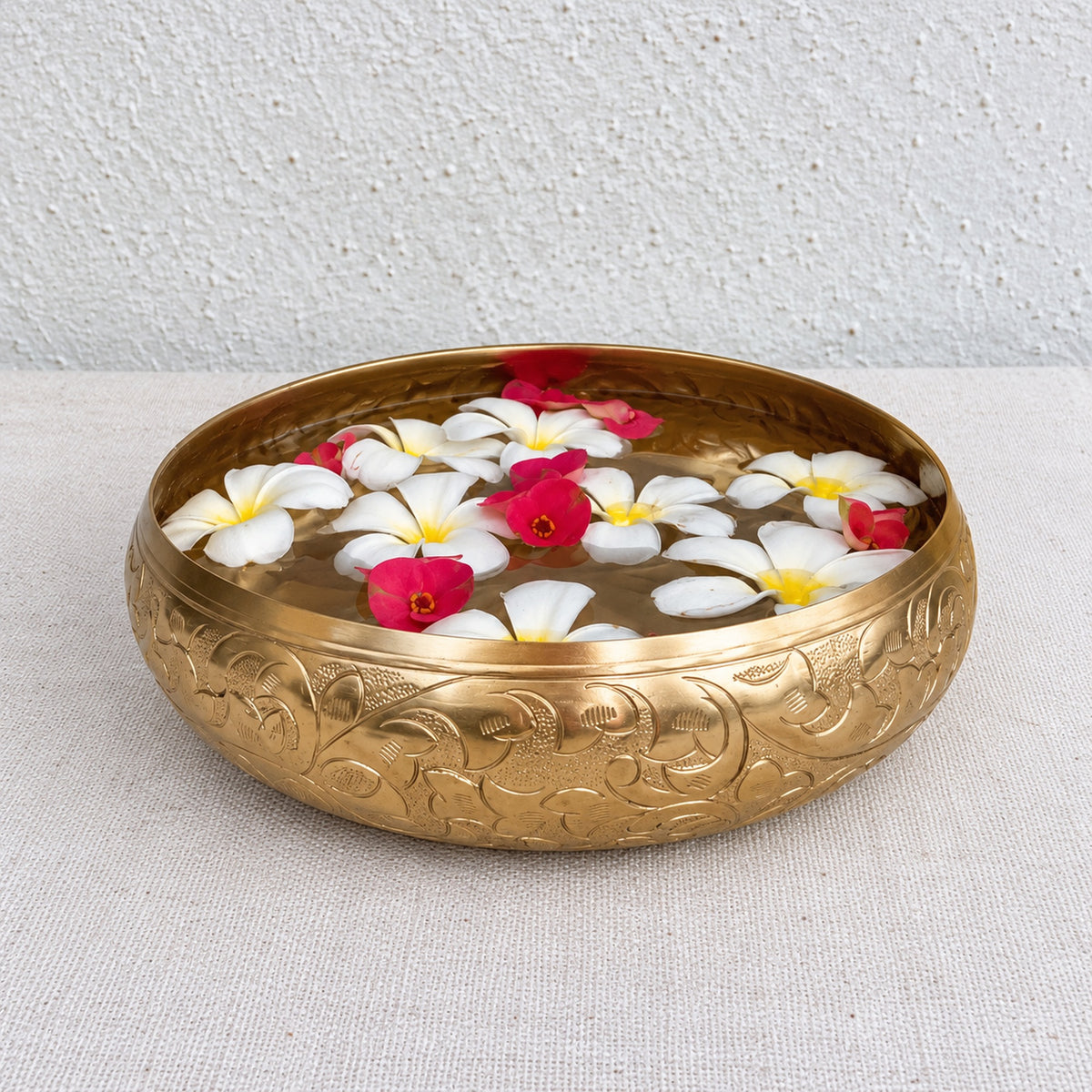 Chitra urli holding water and flowers on a table