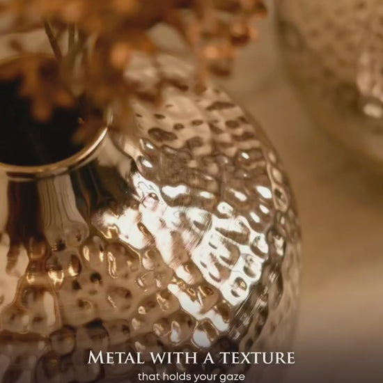 Close-up of the hammered silver finish on the Oria globe vase catching the light