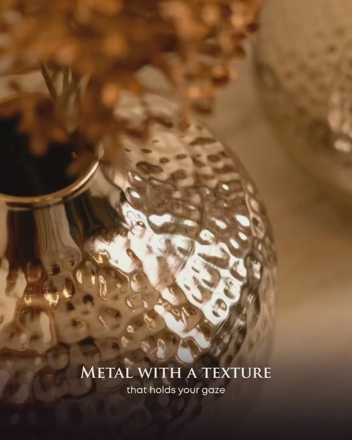 Close-up of the hammered silver finish on the Oria globe vase catching the light